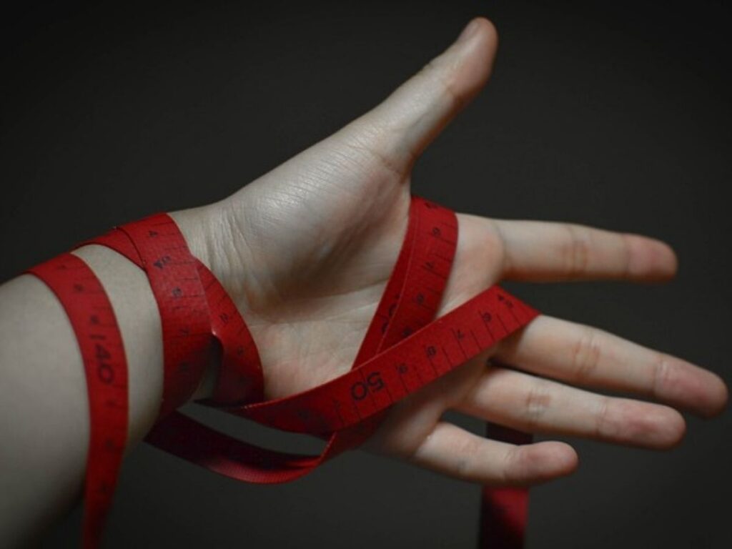 A hand wrapped in lots of red tape