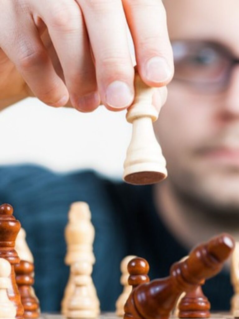 a man considers his next move in a chess game