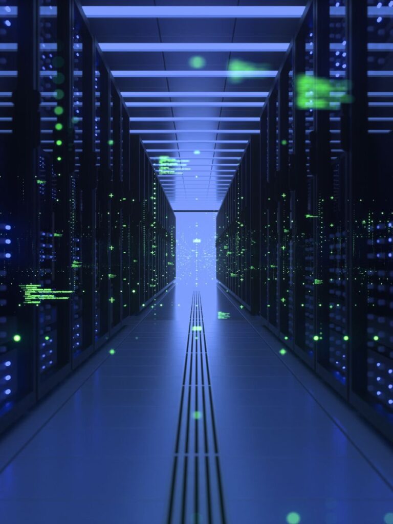 a corridor between banks of computers in a dark room with green flashes like computer code overlaid on top.