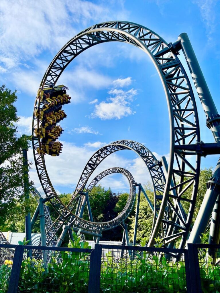 a picture of a loop-de-loop rollercoaster on a sunny summer day